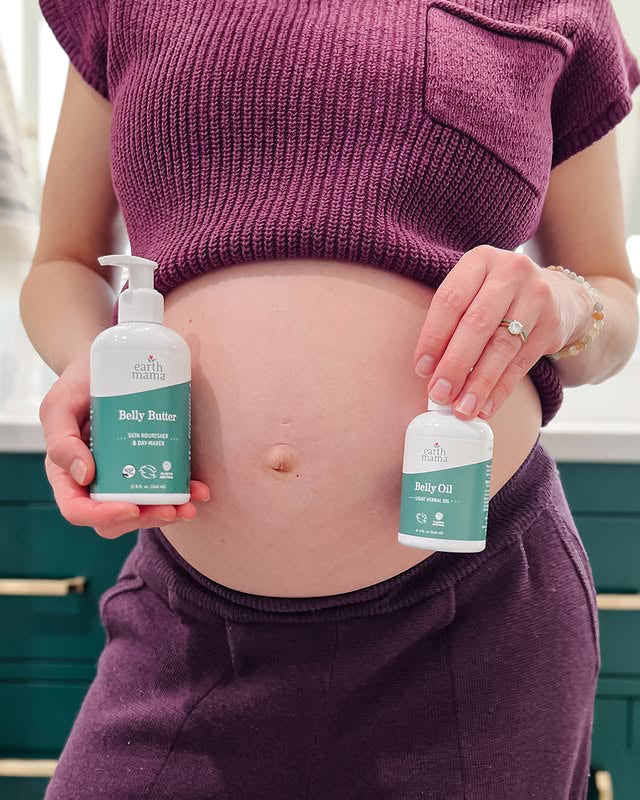 Person holding two bottles of 'Belly Butter' and 'Baby Oil' with a visible baby bump.